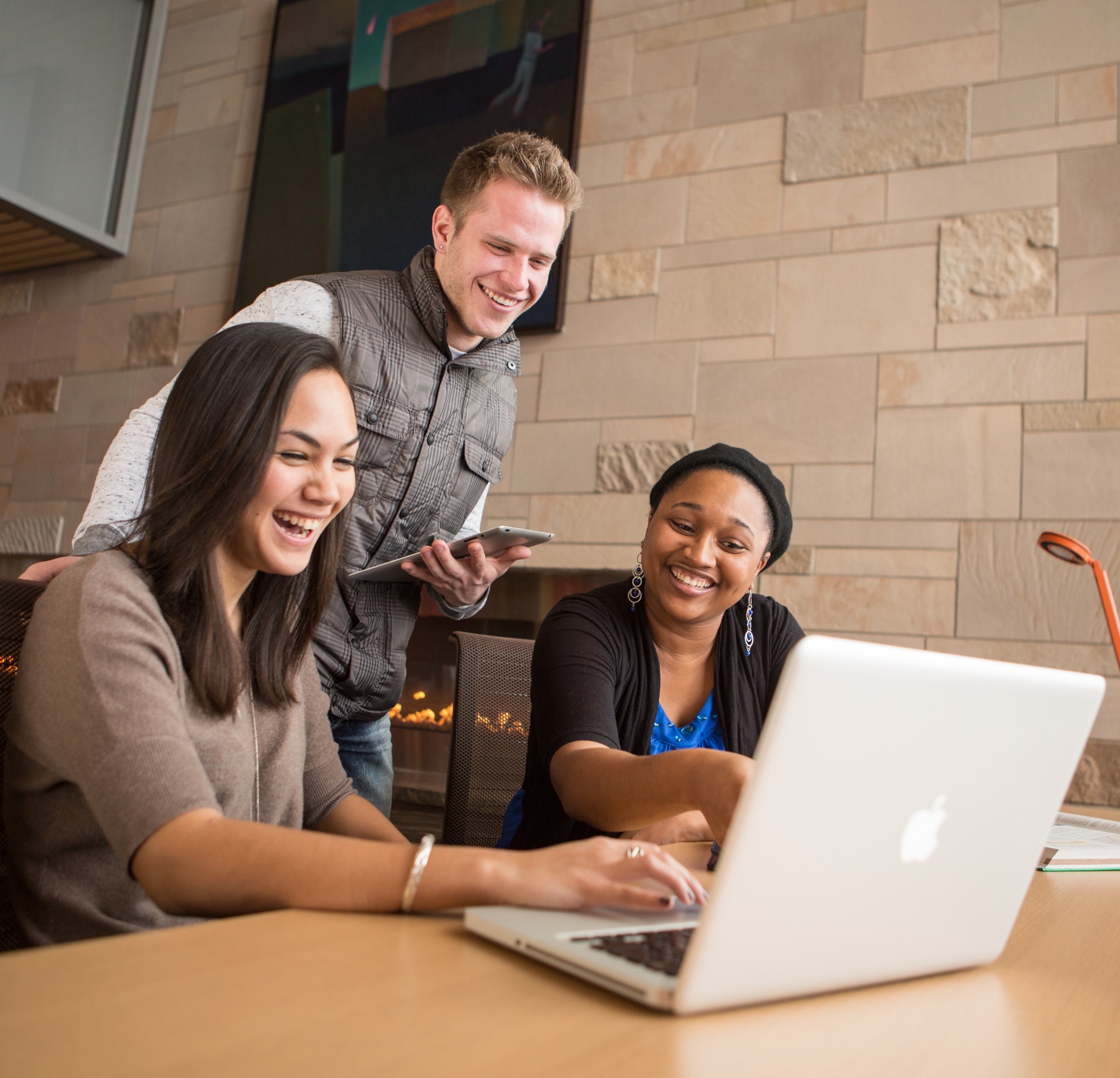 students working together on a laptop